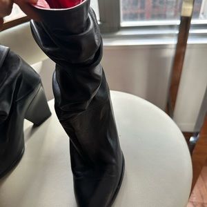 Black leather mint condition with red lining.